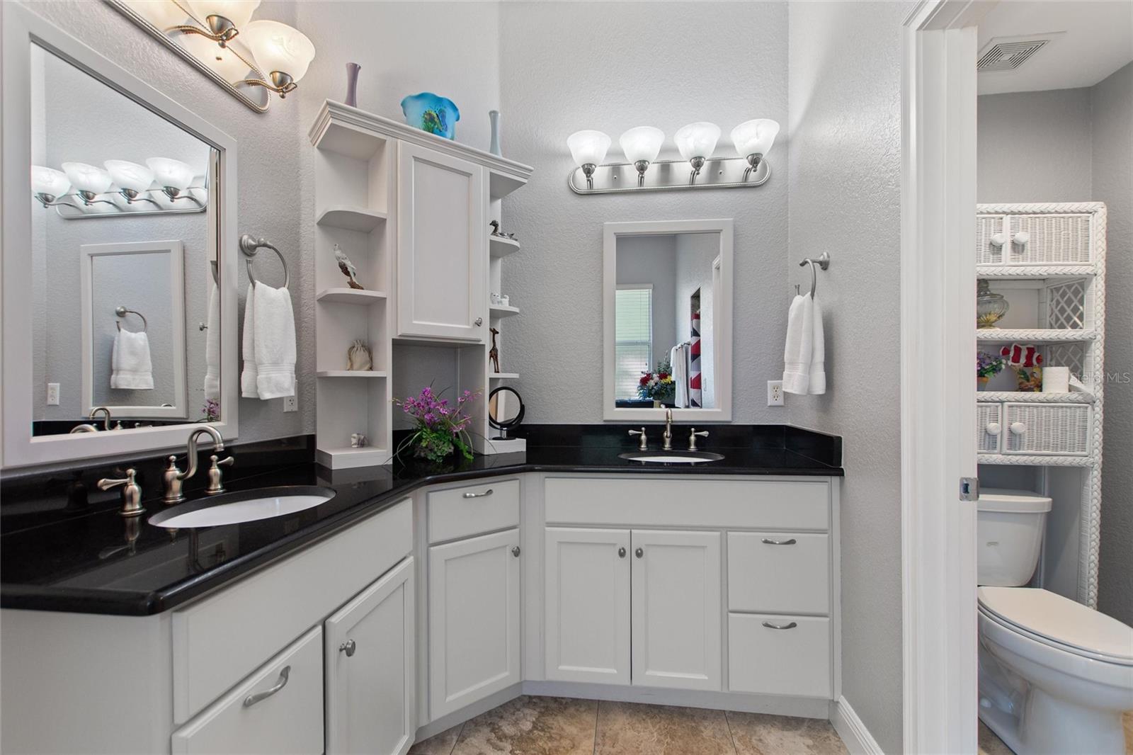 Master bathroom with dual vanities and private toilet room.