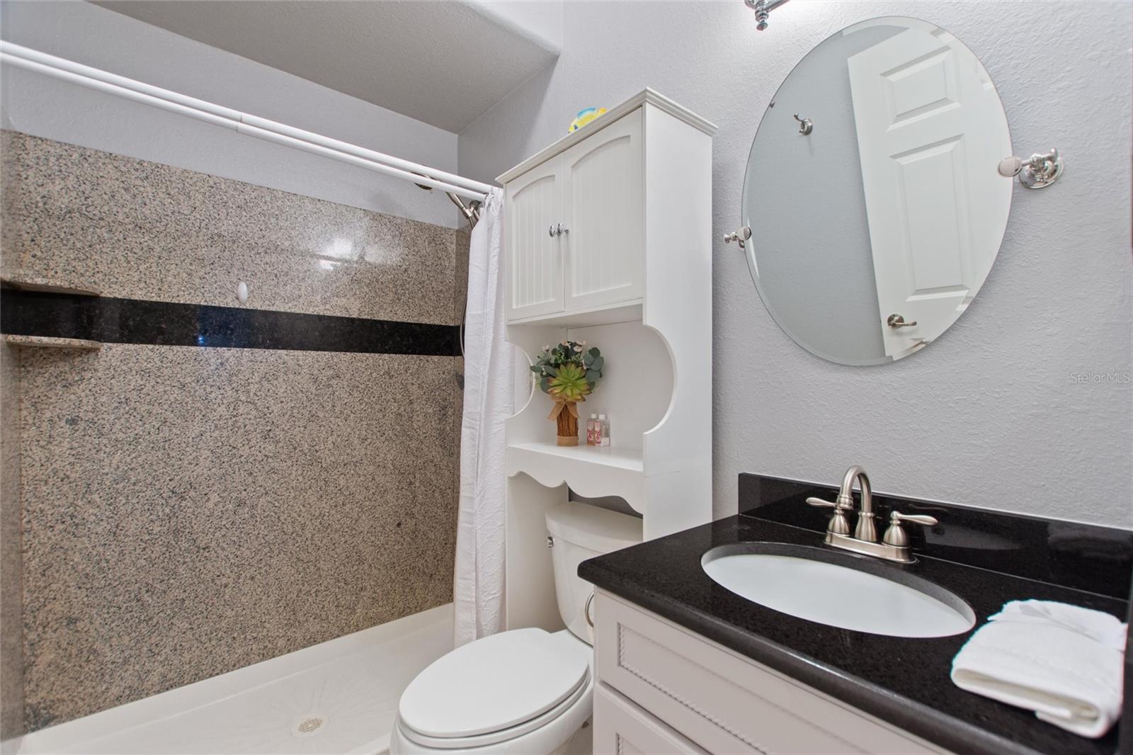 Bathroom 2 with bathtub/ tiled shower combo.