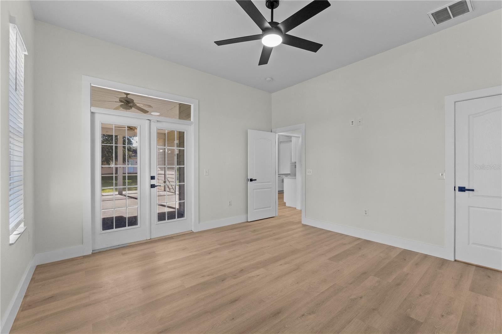 Primary Bedroom 1 with French Doors to Patio