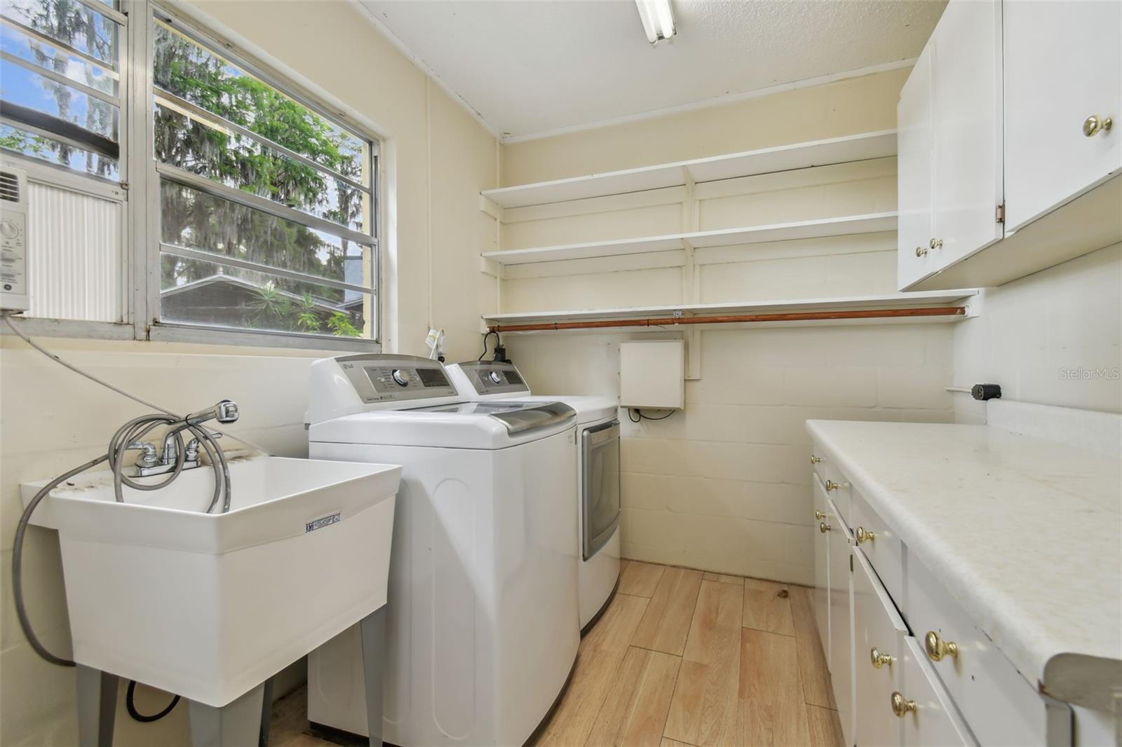 Spacious laundry room adjacent to the carport