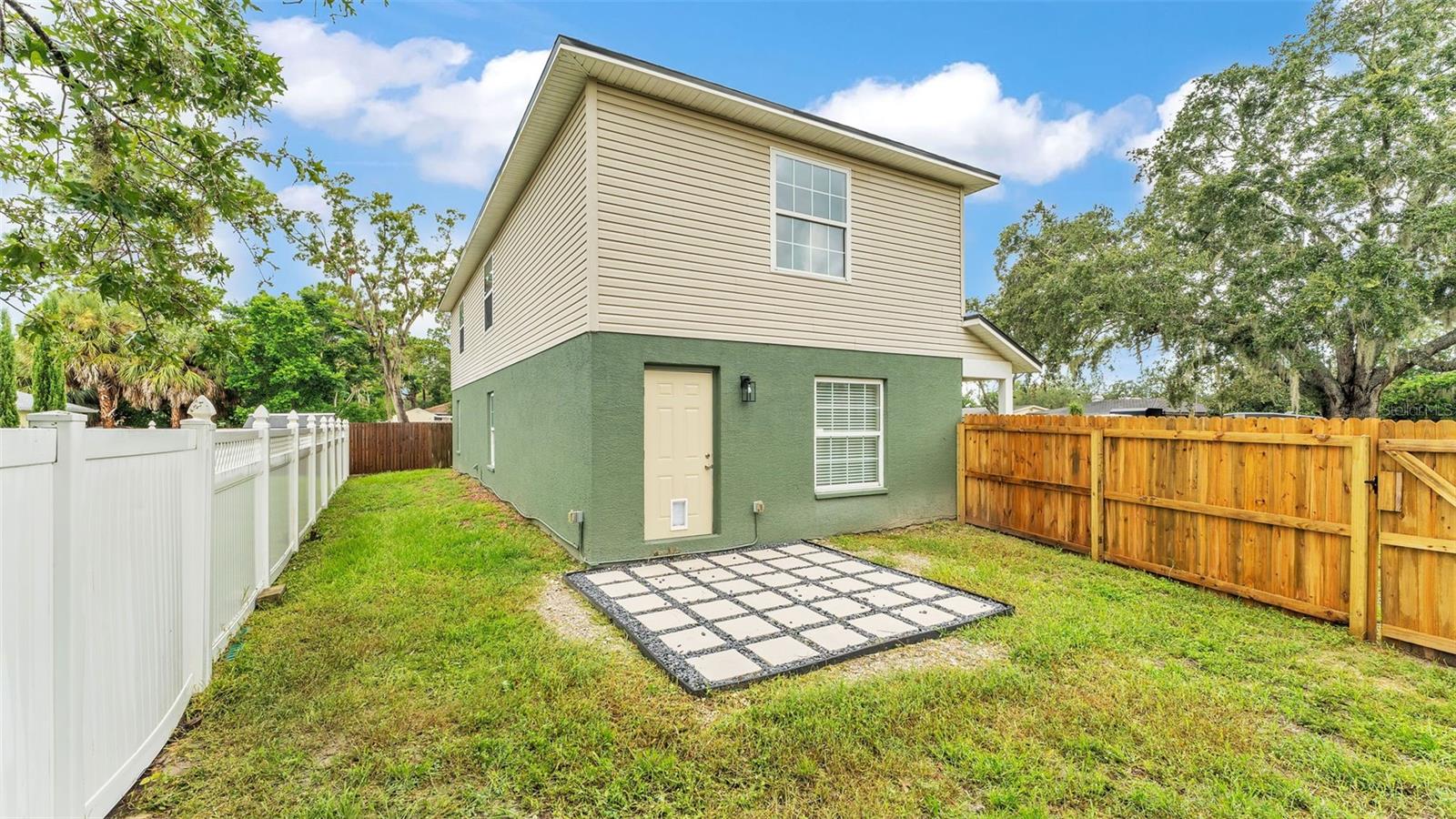 Backyard with brand new wooden fence (2025)