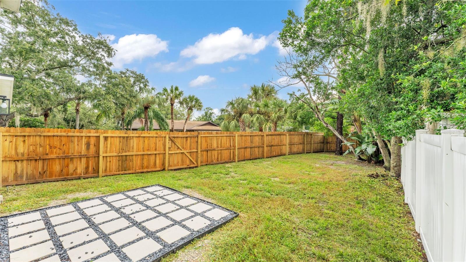 Backyard with brand new wooden fence (2025)
