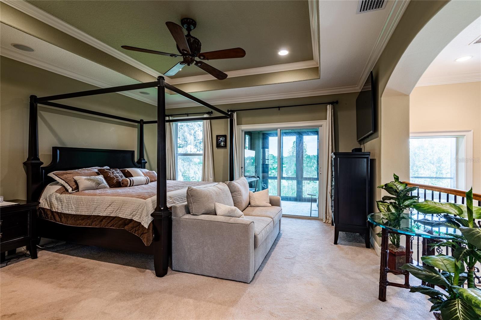 Master bedroom with sliding glass doors to fully enclosed with a/c observation room.  Could be office, or sitting room overlooks the hot tub and lake area.