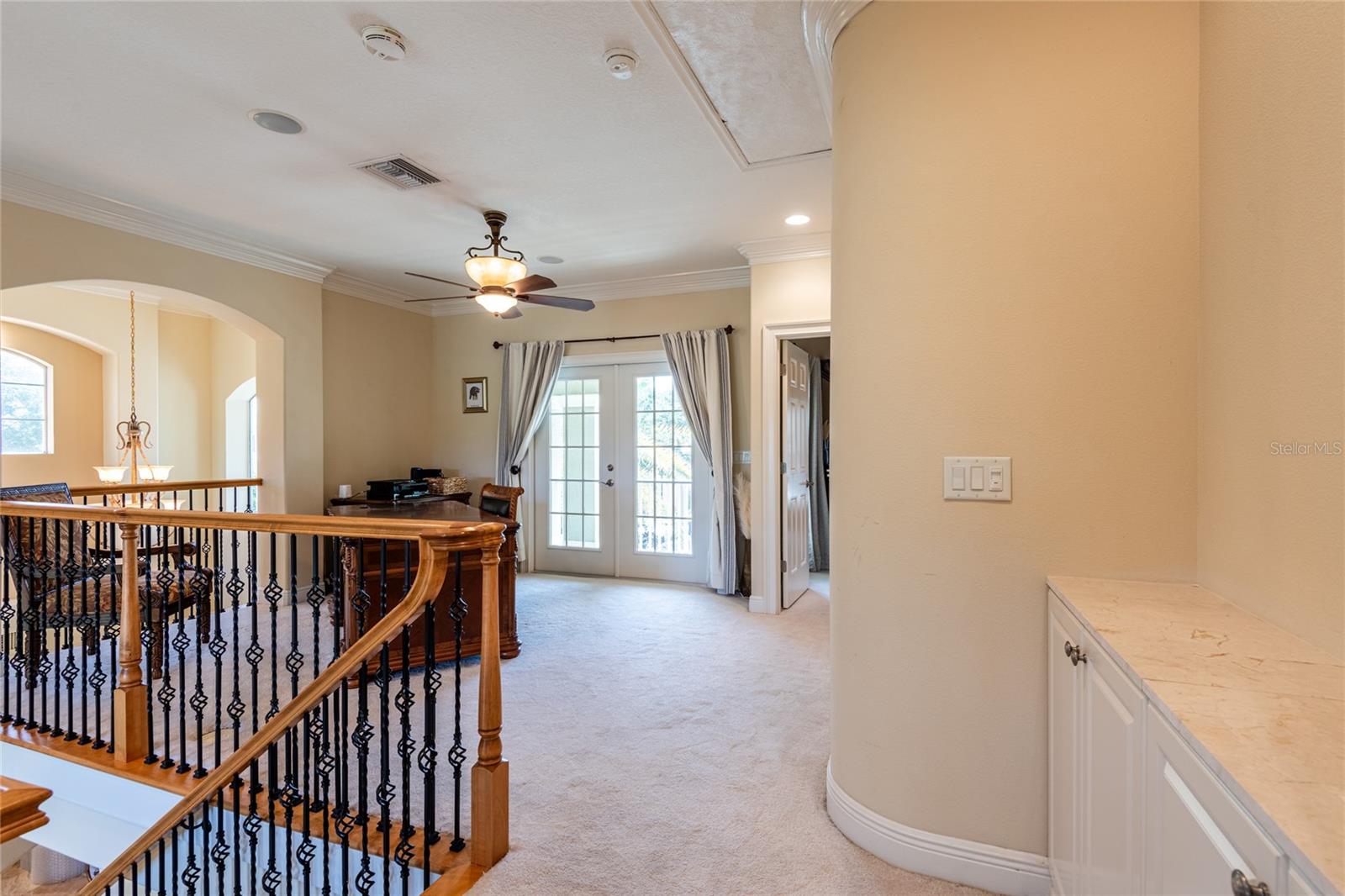 Office at top of the staircase.  French doors lead to the open balcony.
