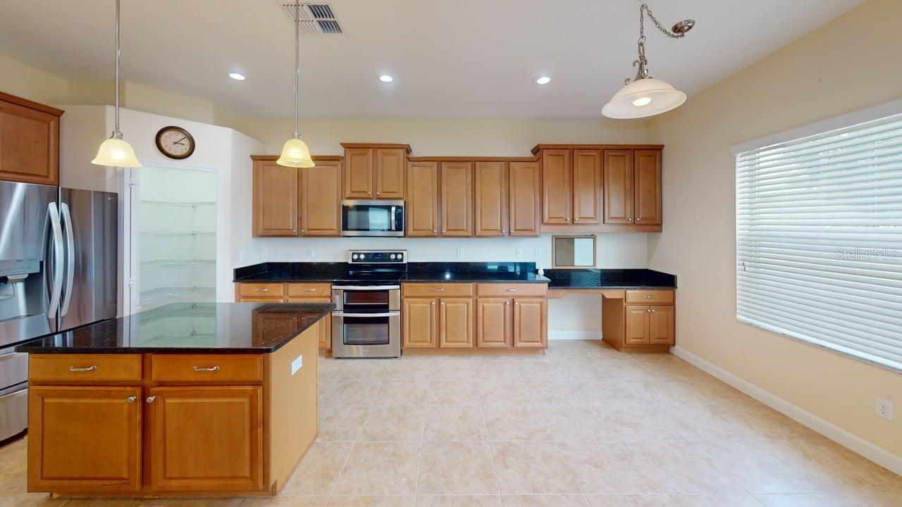 Huge kitchen with Island, Stainless steel appliances, 2 walk-in Pantry's, eat in space looking out to the back yard View from the family room