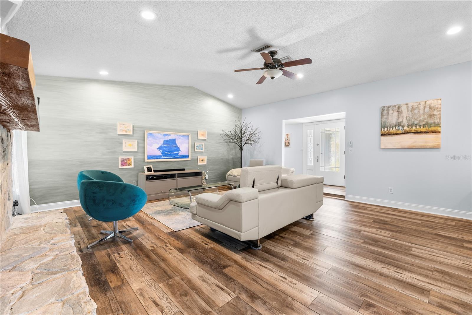 Furnished photos taken of living area and foyer before the property was vacant. Furniture and decorations do not convey.