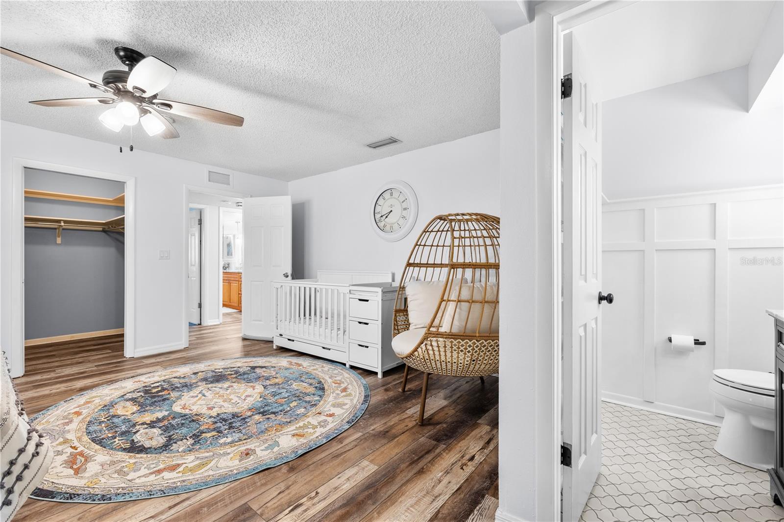 Furnished photos taken of primary bedroom and walk-in closet before the property was vacant. Furniture and decorations do not convey.