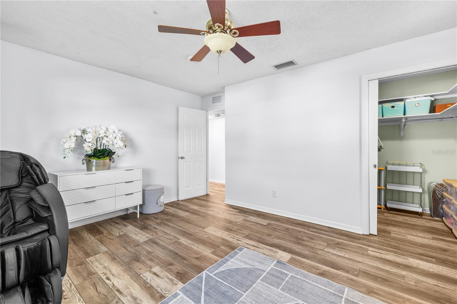 Furnished photos taken of bedroom 2 and walk-in closet before the property was vacant. Furniture and decorations do not convey.