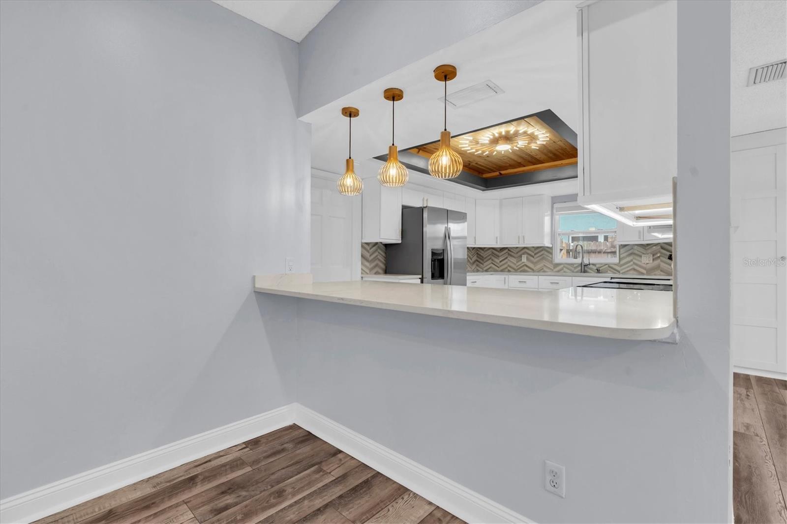 Unfurnished views of kitchen bar provided to showcase space and support your own decorating ideas.