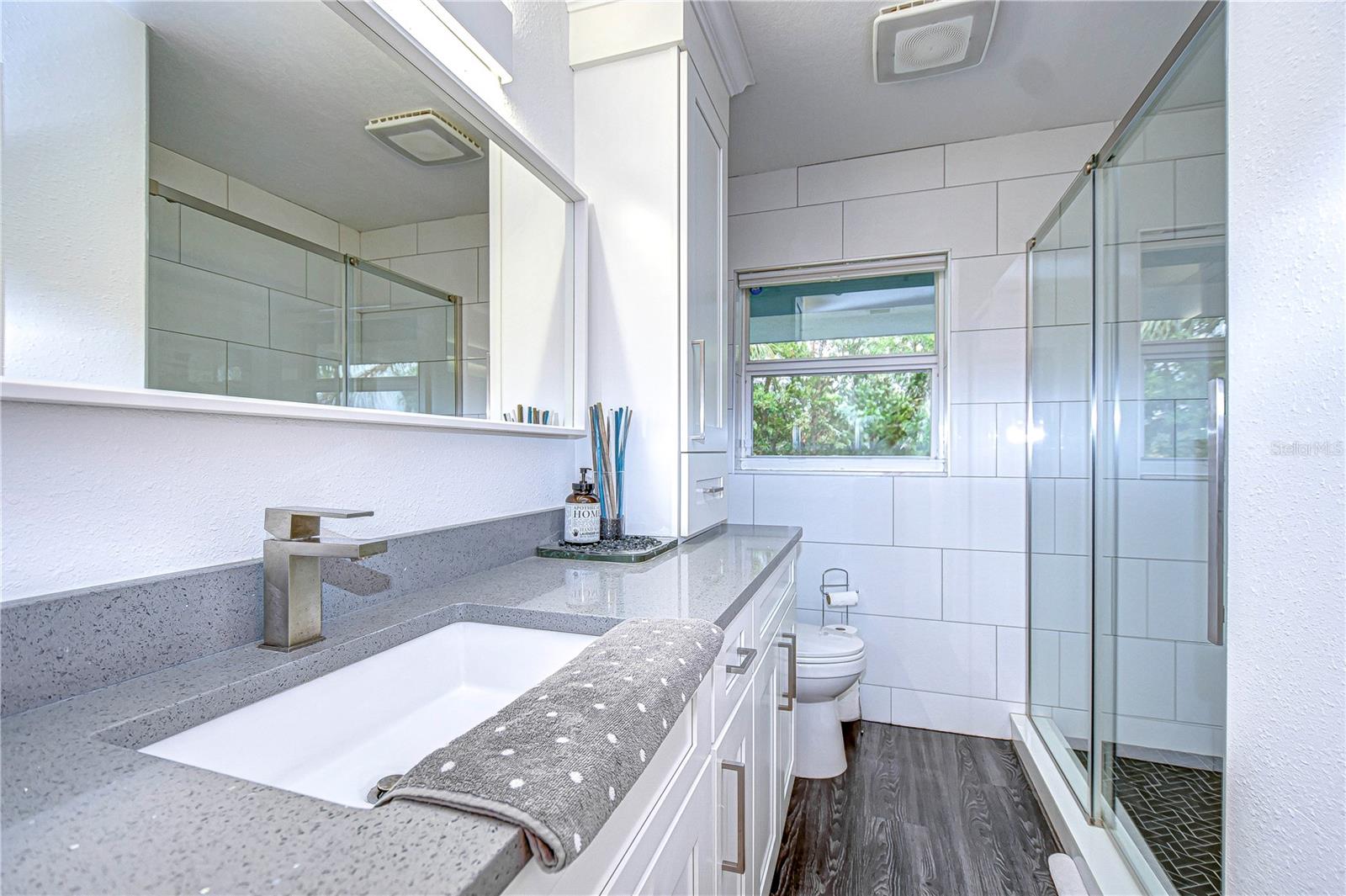 Remodeled bathroom with glass enclosed walk in shower