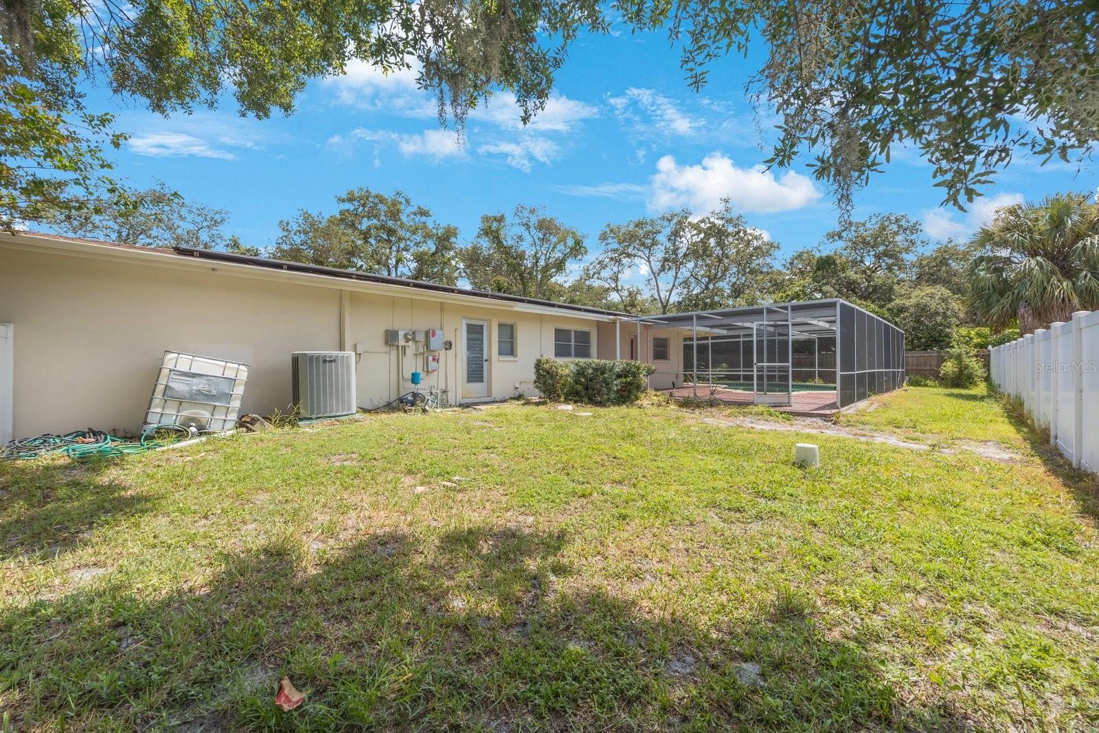 Lots of yard in this large parcel even with inground bird caged pool!