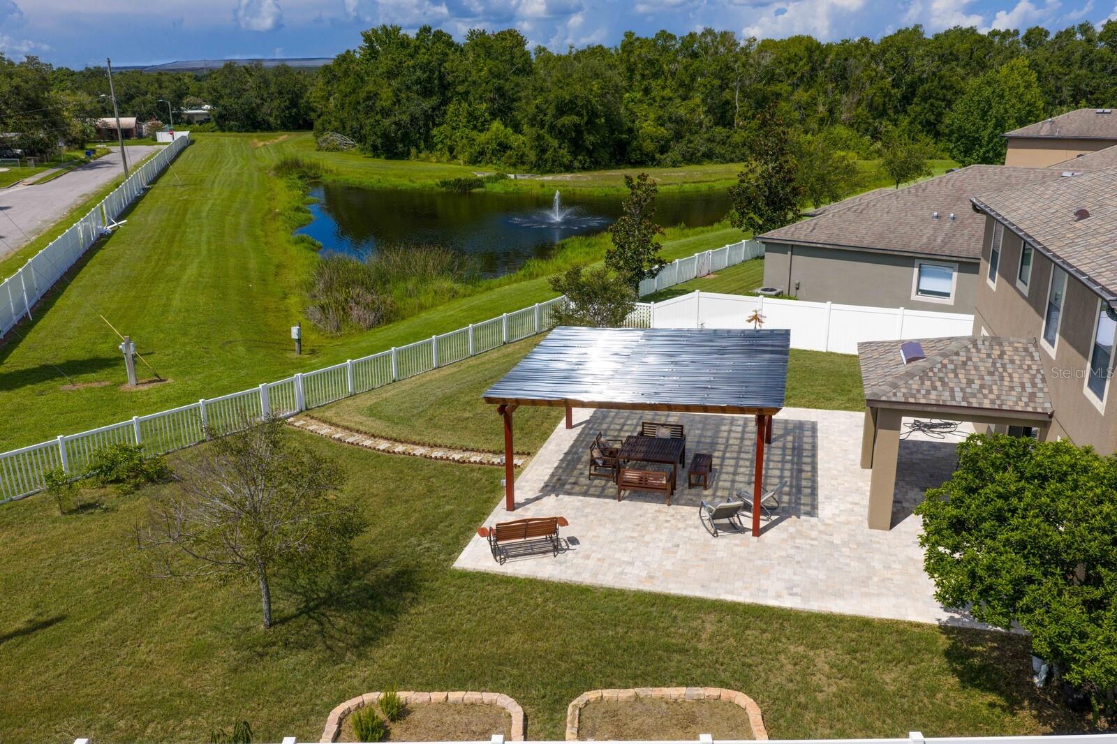Huge Fenced Back Yard With View Of Pond & Covered Brick Paved Patio
