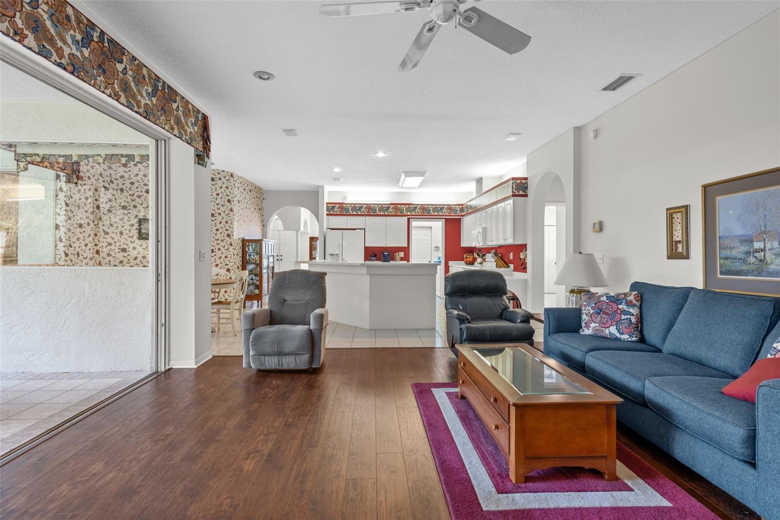 Family Room with sliders to outdoor screened in space