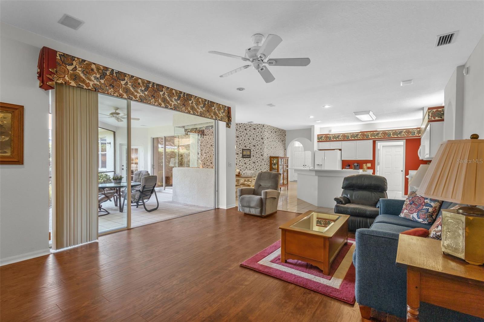 Family Room with sliders to outdoor screened in space