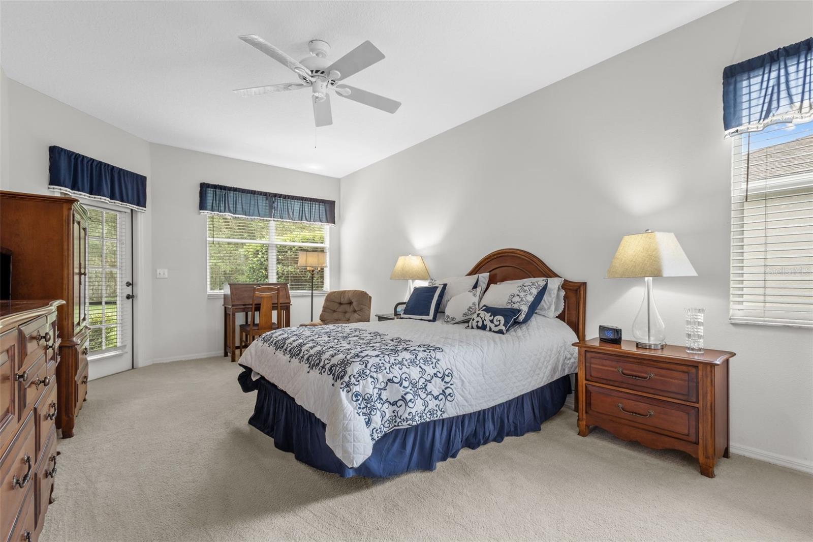 Primary Suite has a door to the outside porch, views of the backyard, and an en suite bathroom