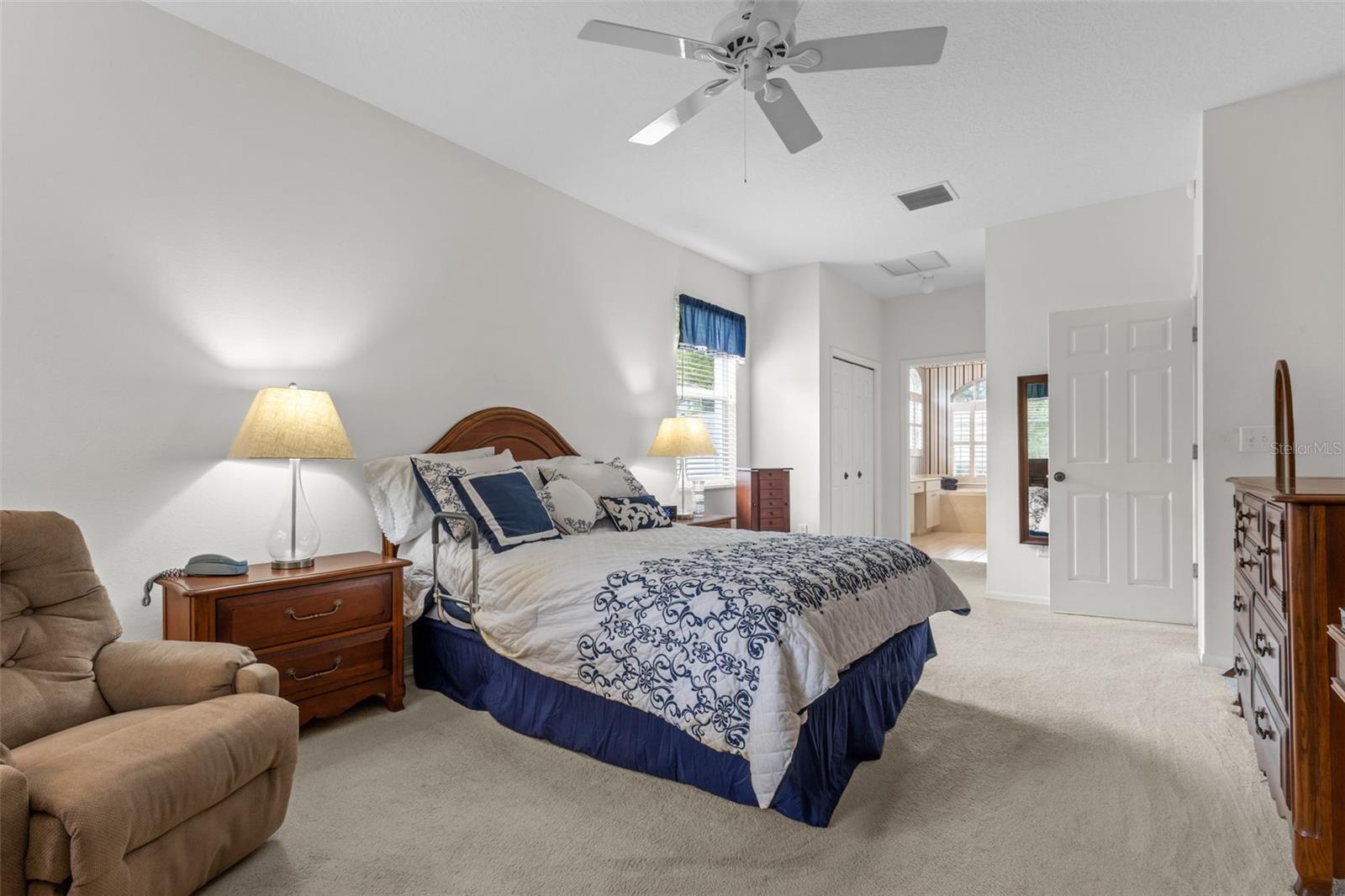 Primary Suite has a door to the outside porch, views of the backyard, and an en suite bathroom