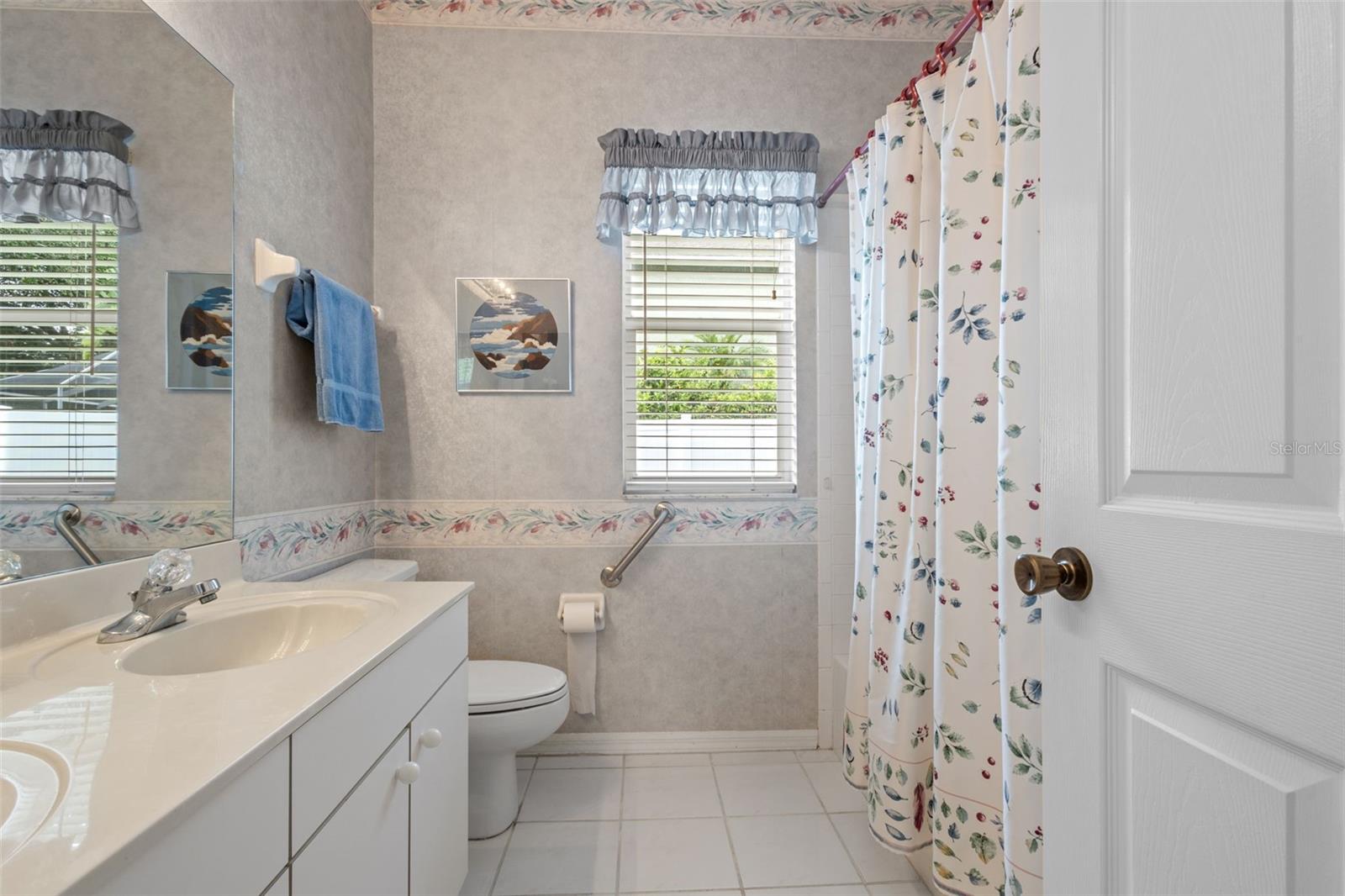 Bathroom 2 - located between bedrooms 2 and 3 - has a tub shower combination and dual sinks