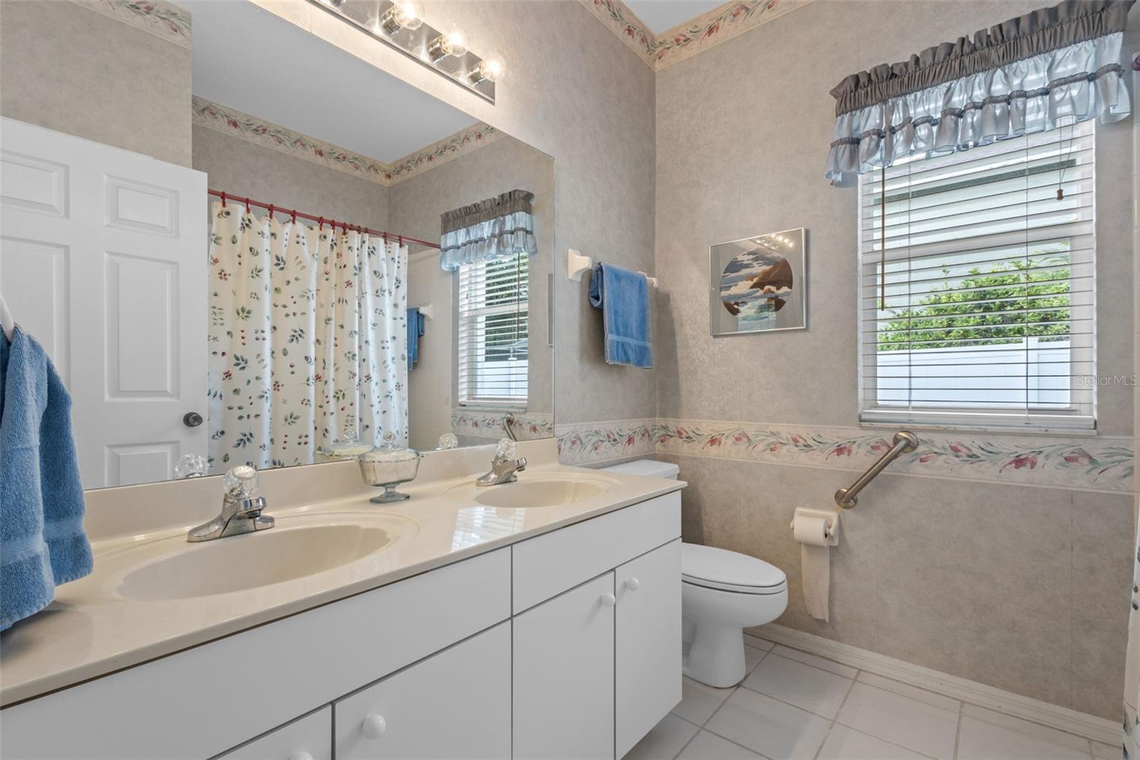 Bathroom 2 - located between bedrooms 2 and 3 - has a tub shower combination and dual sinks