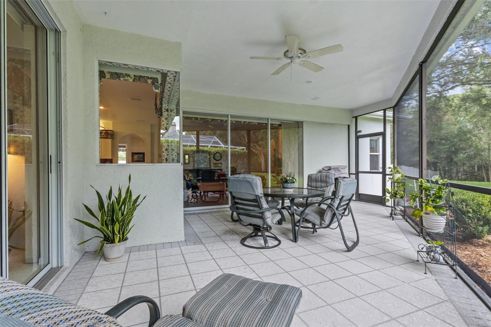 Screened-in patio perfect for relaxing or entertaining—overlooking the private backyard and conservation.