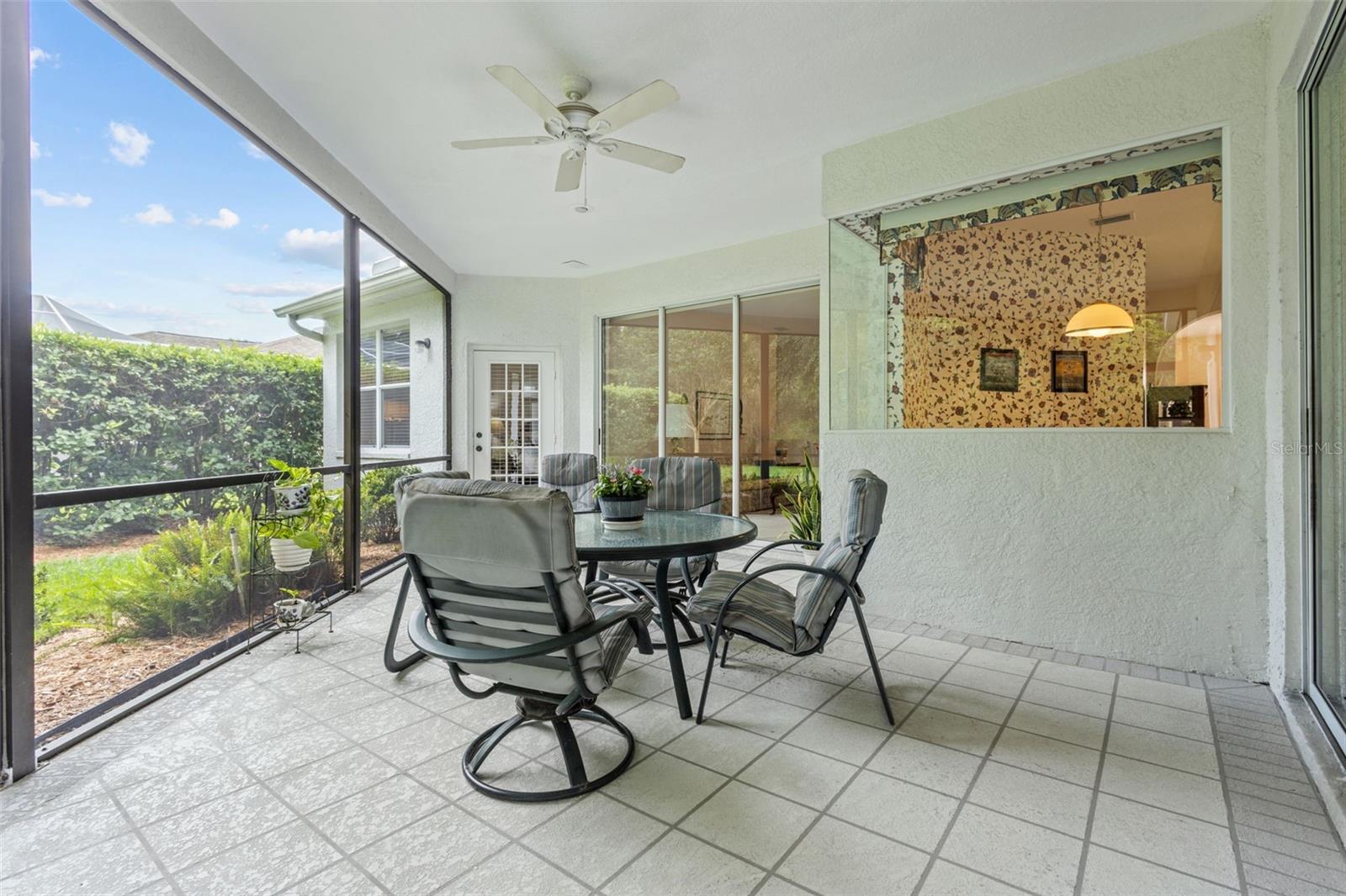 Screened-in patio perfect for relaxing or entertaining—overlooking the private backyard and conservation.