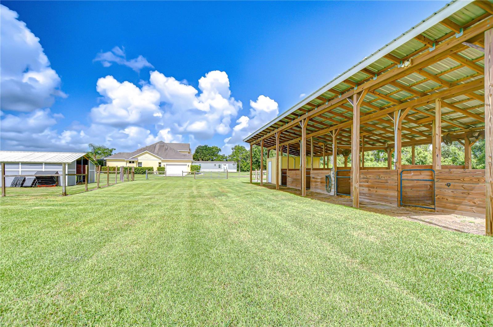 Four-stall horse barn with 30-ft runs—equestrian ready!