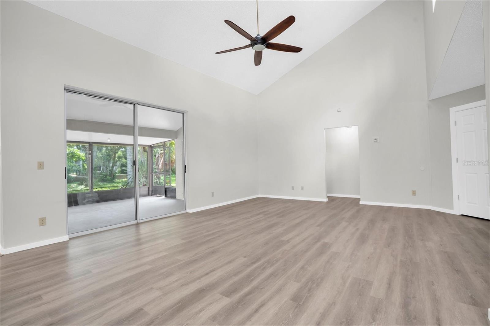 Great room with NEW Vinyl Plank Flooring and access to screened porch
