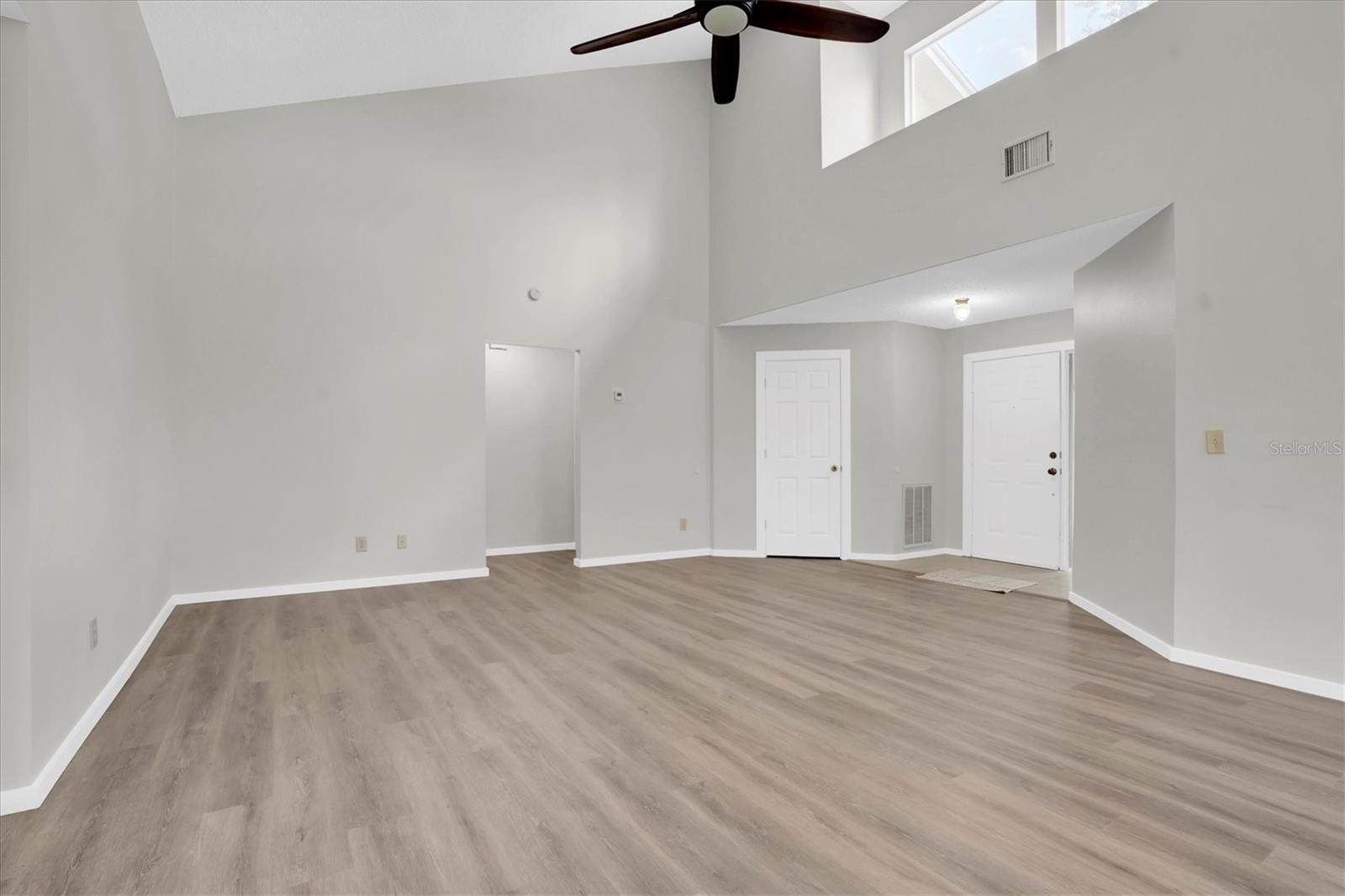 Great room with 17' high ceilings and transom windows