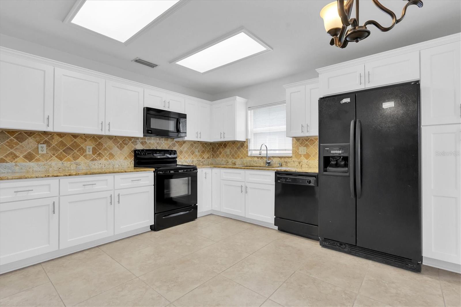 Large open kitchen with NEW cabinets and tile floors
