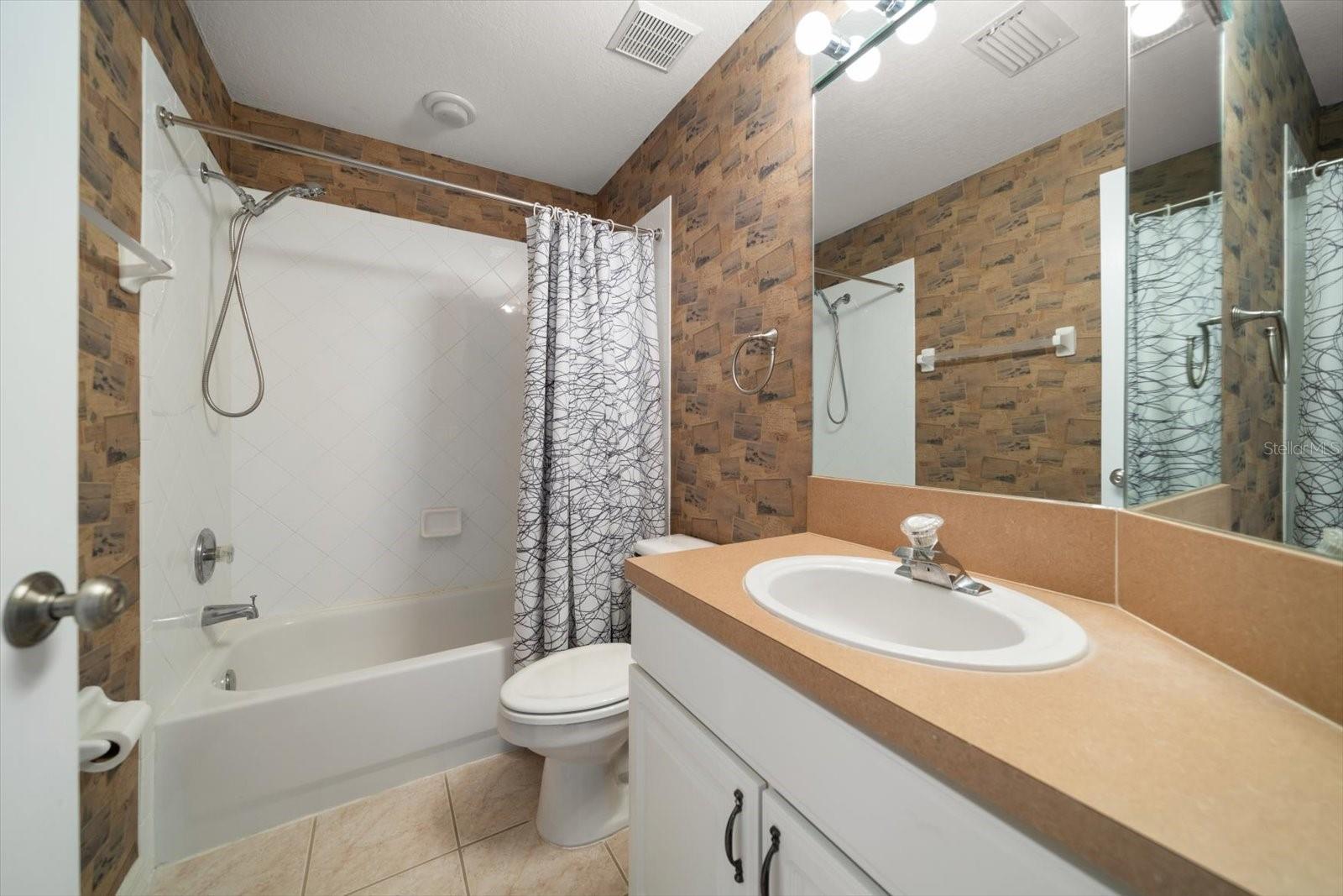 Guest bathroom with tub and shower