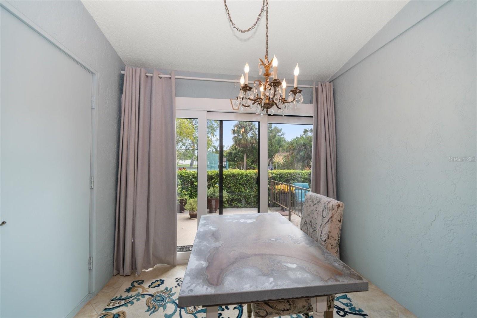 Adorable sunroom overlooking patio and tennis courts