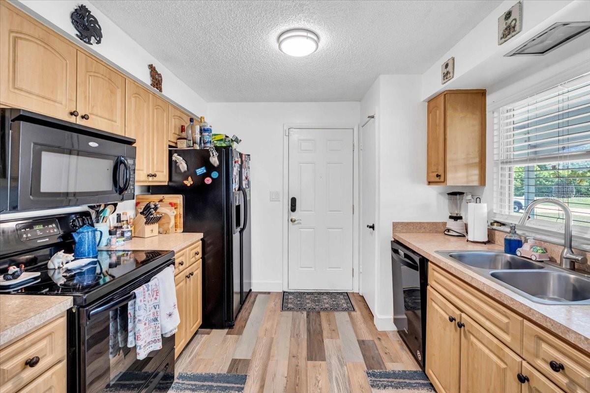 Kitchen with a door to the carport