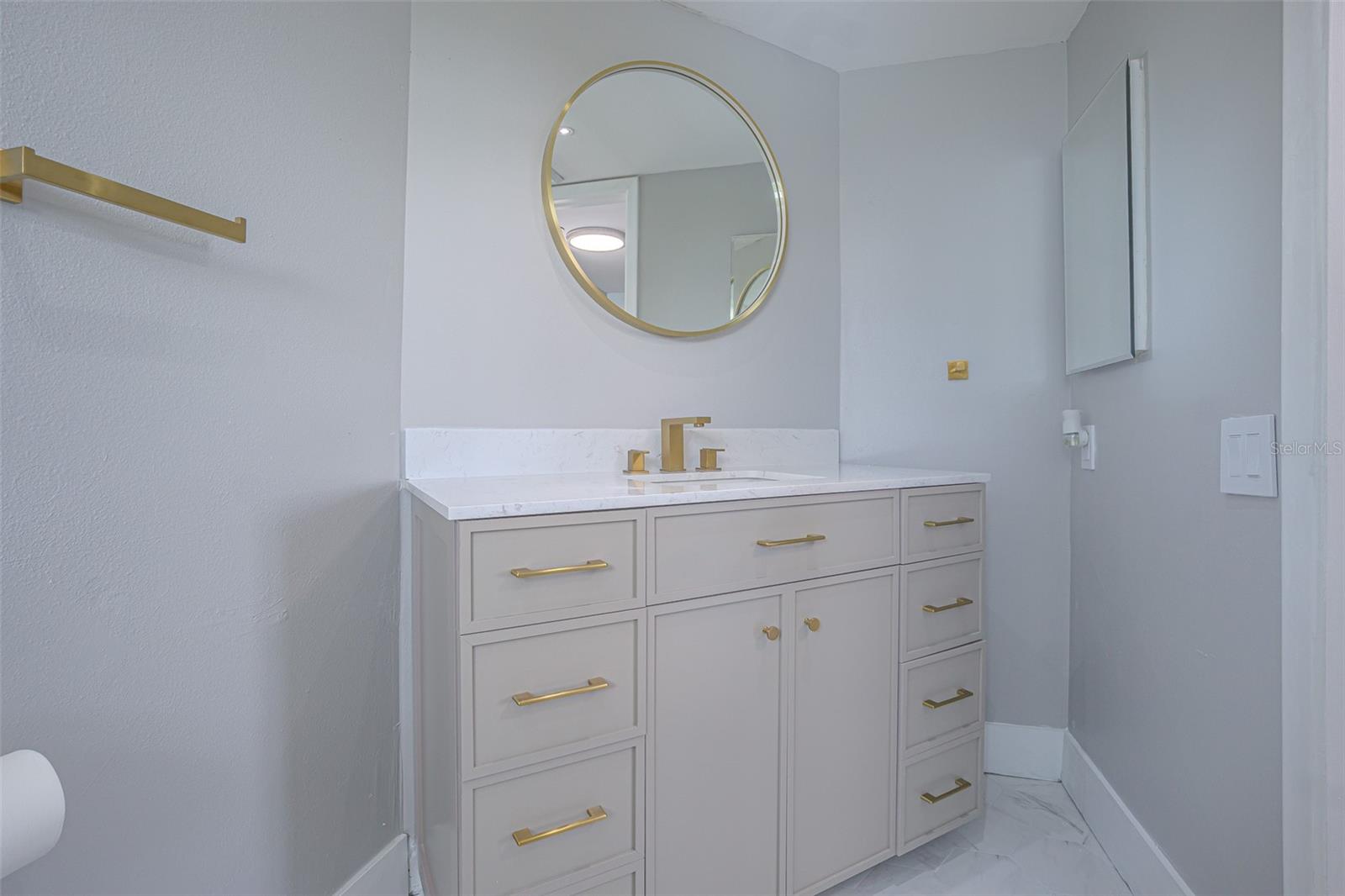 THE MASTER BATHROOM HAS BEAUTIFUL GOLD ACCENTS