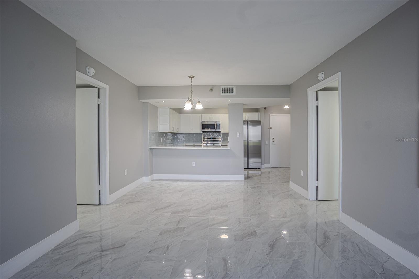 AN OPEN FLOOR PLAN FLOWS FROM THE LIVING AND DINING AREA