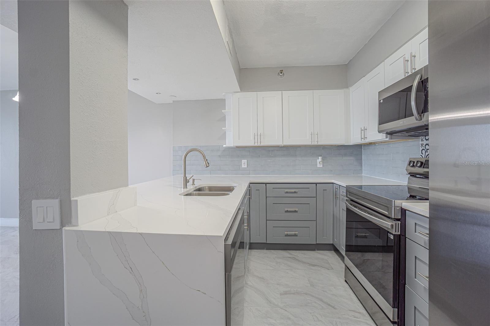 WOW!  EXCEPTIONALLY LARGE AND WIDE CORIAN COUNTERTOP WITH A FLOWING WATERFALL OF CORIAN