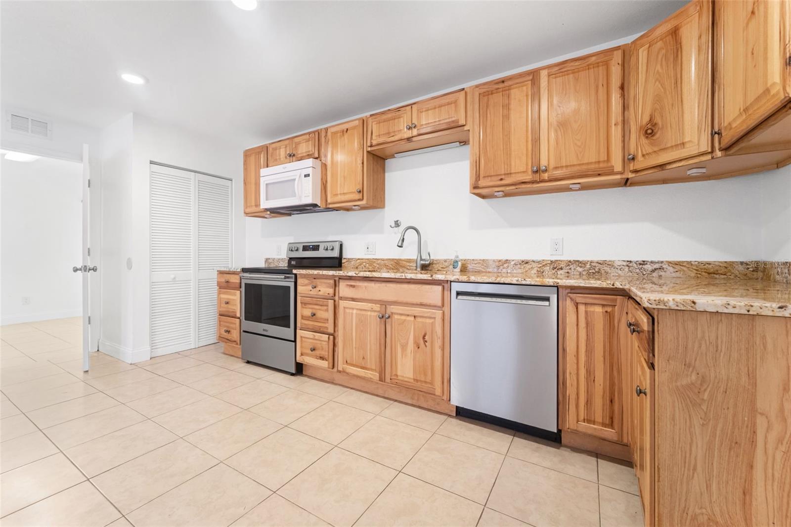 Granite countertops in the kitchen and wood cabinets