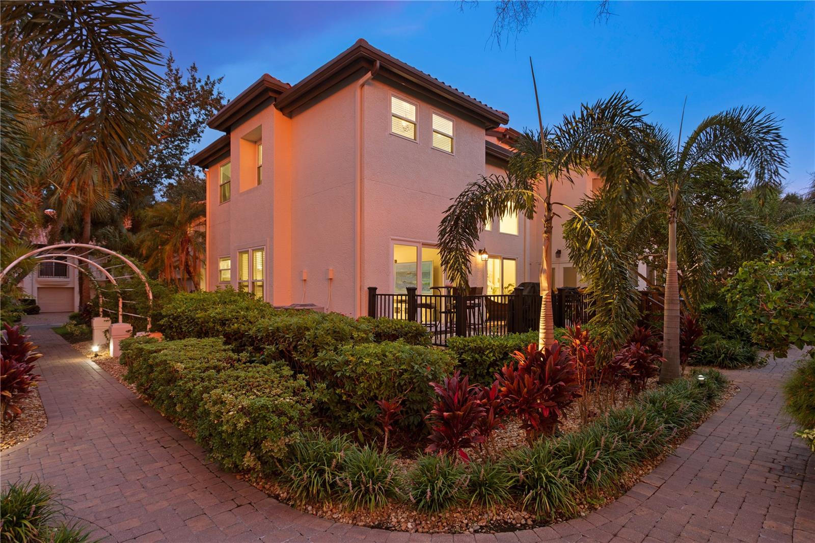 Enjoy a deck surrounded by vibrant greenery with just a short stroll to the community pool