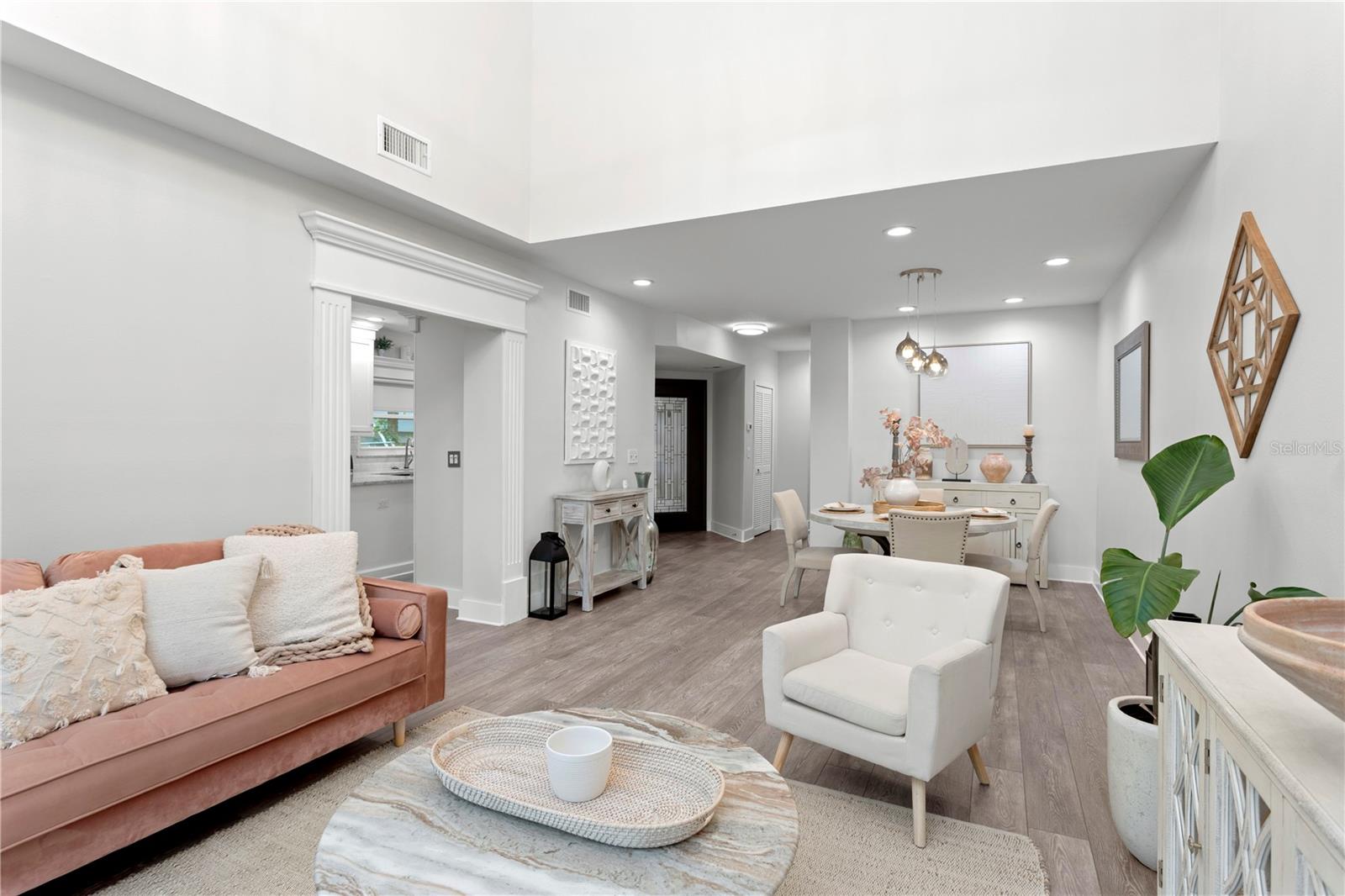 A lovely open floor plan seamlessly connects the front entrance, dining area, and family room, creating an inviting and airy flow throughout the main living spaces