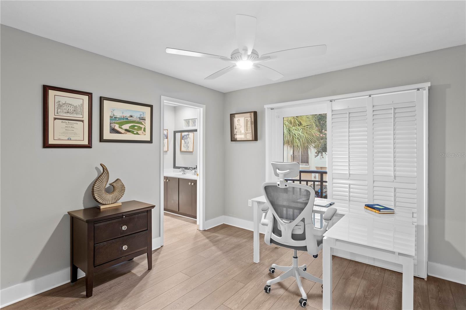 The second bedroom is adorned with elegant plantation shutters