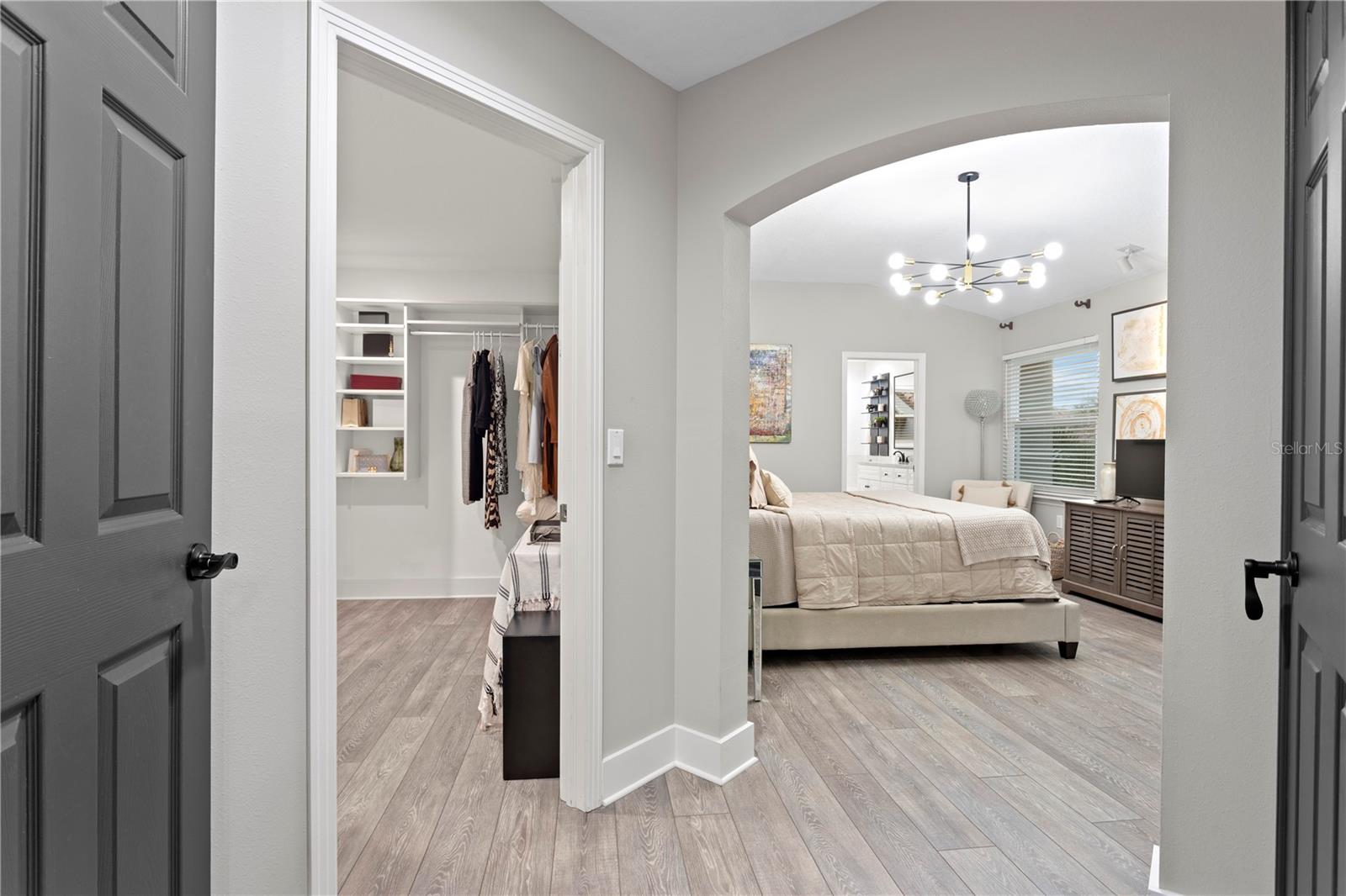 The owner’s suite is a true retreat, showcasing a grand double-door entry