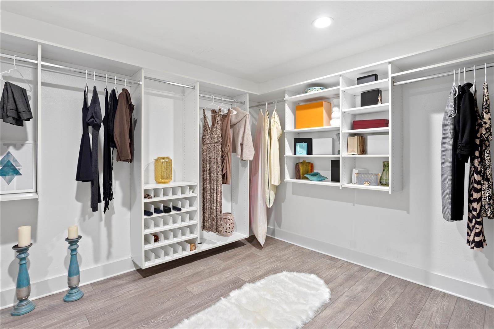 An expanded walk-in closet with built-in organizers