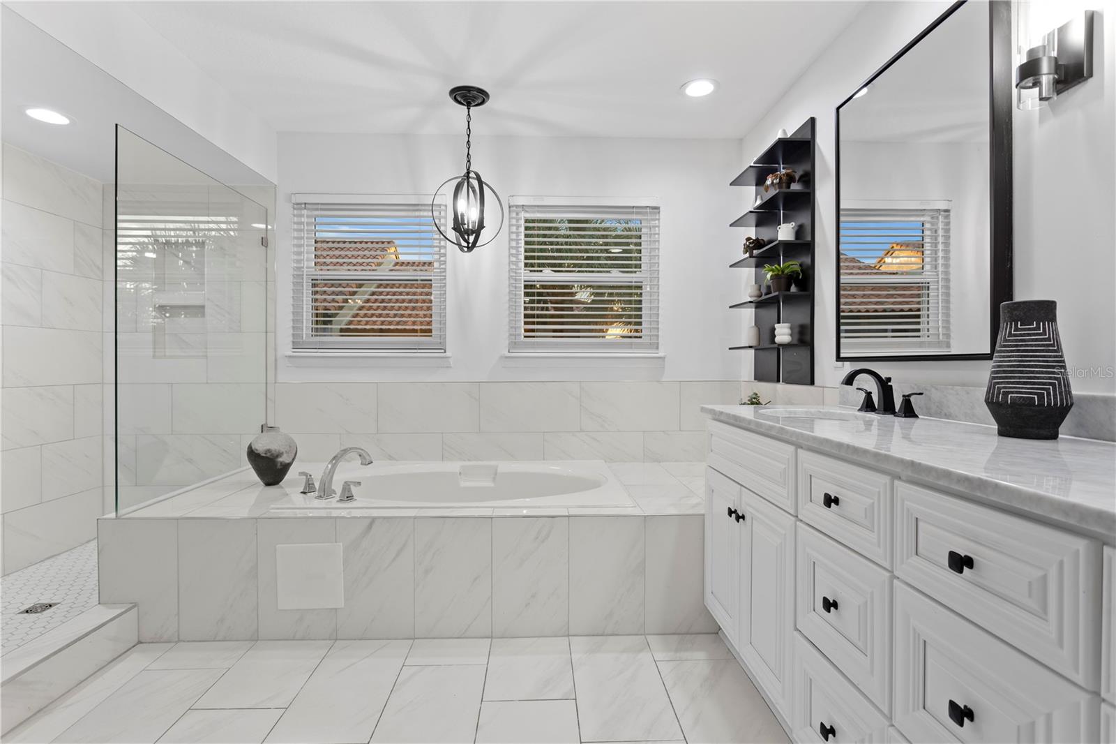 A beautifully updated en-suite bath with a soaking tub and separate shower.