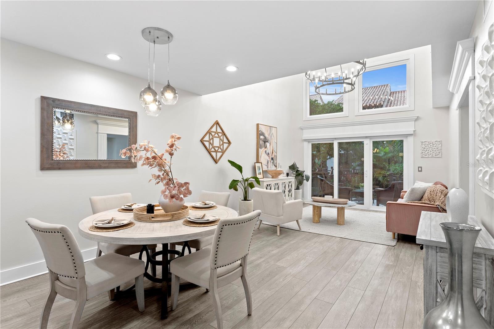 The family room and dining area greet you with soaring ceilings and an abundance of natural light, creating a warm and inviting atmosphere