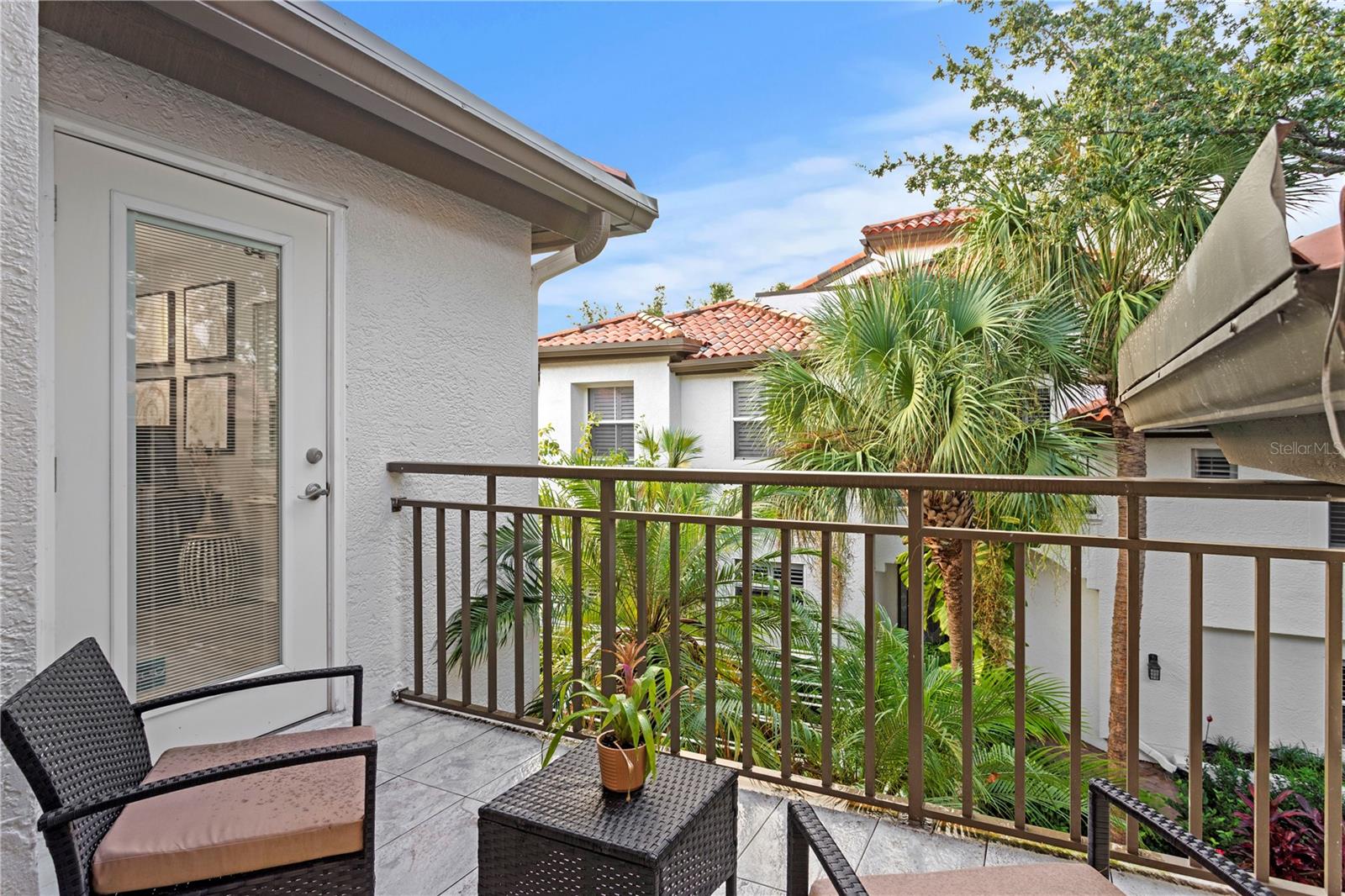 Step out from the primary bedroom onto a charming patio—an ideal spot to savor coffee or unwind with a book.