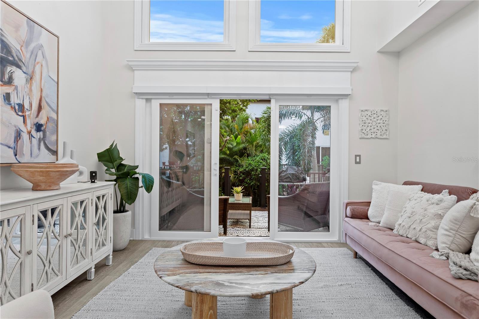 The family room features newer impact-rated sliding glass doors that open to a spacious deck, seamlessly blending indoor and outdoor living