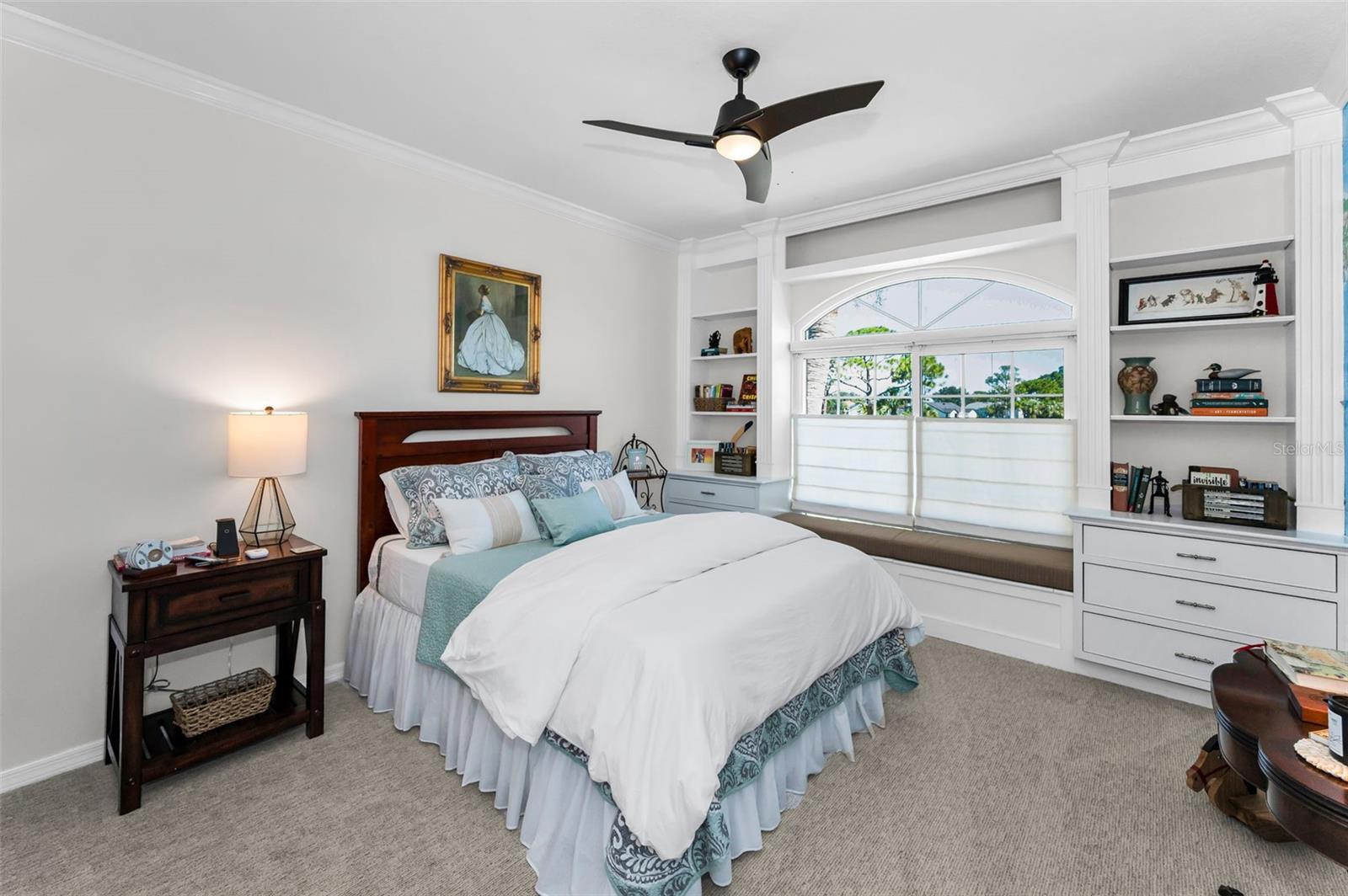 Bedroom with ceiling fan and window seat