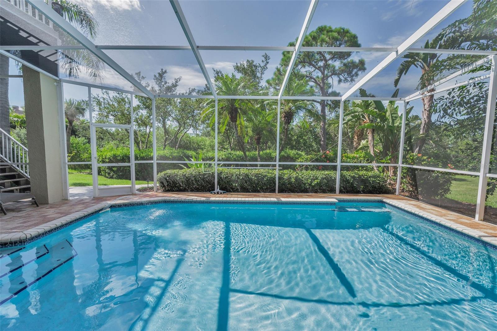Private yard beyond enclosed pool