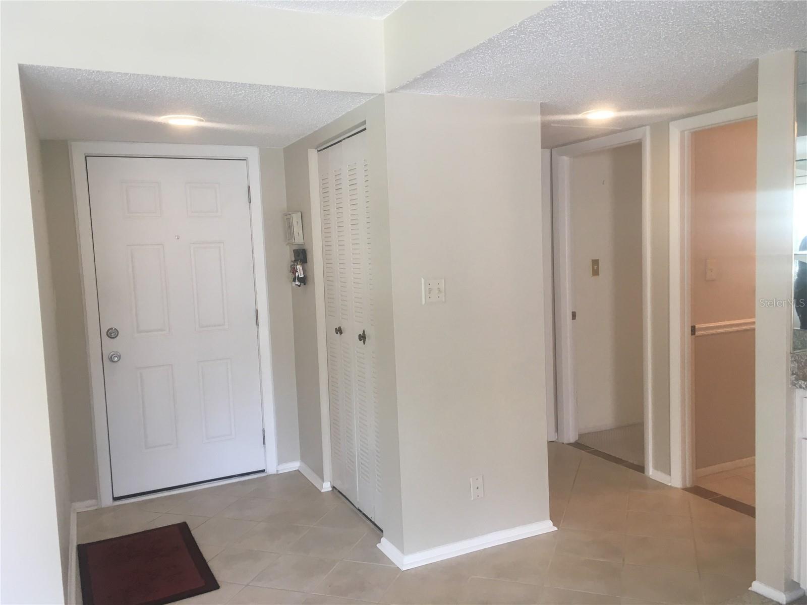 Secondary bedroom on other side of closet and guest bathroom to the right