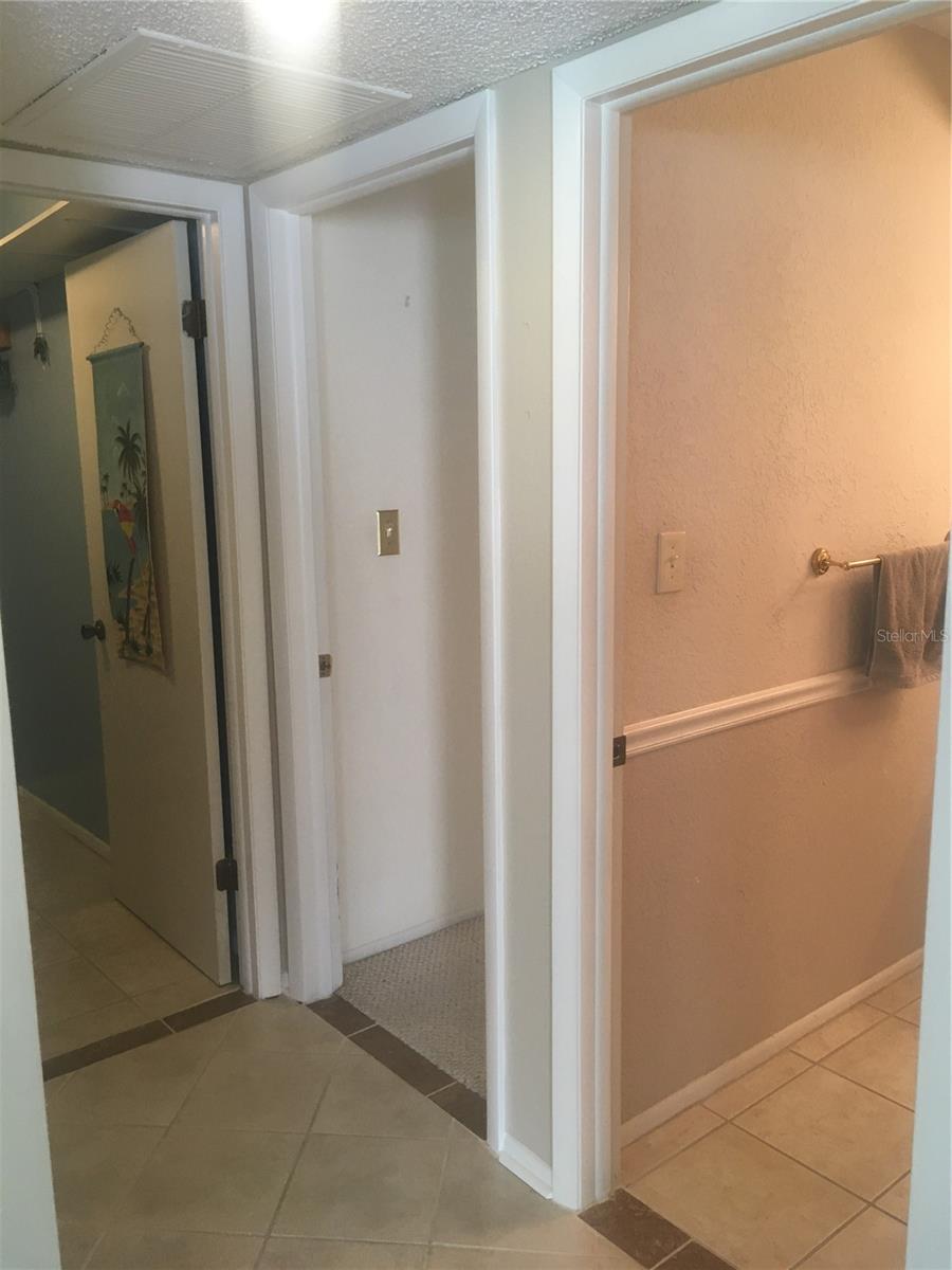 Laundry room on left, second bedroom in middle, guest bath on right