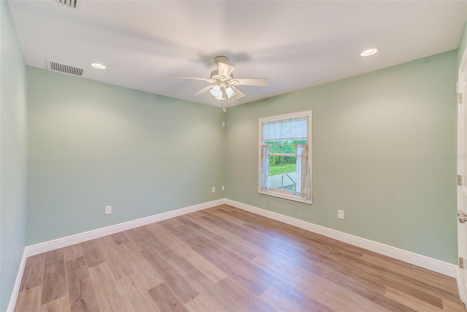 Bedroom 2 with water views and luxury vinyl plank flooring
