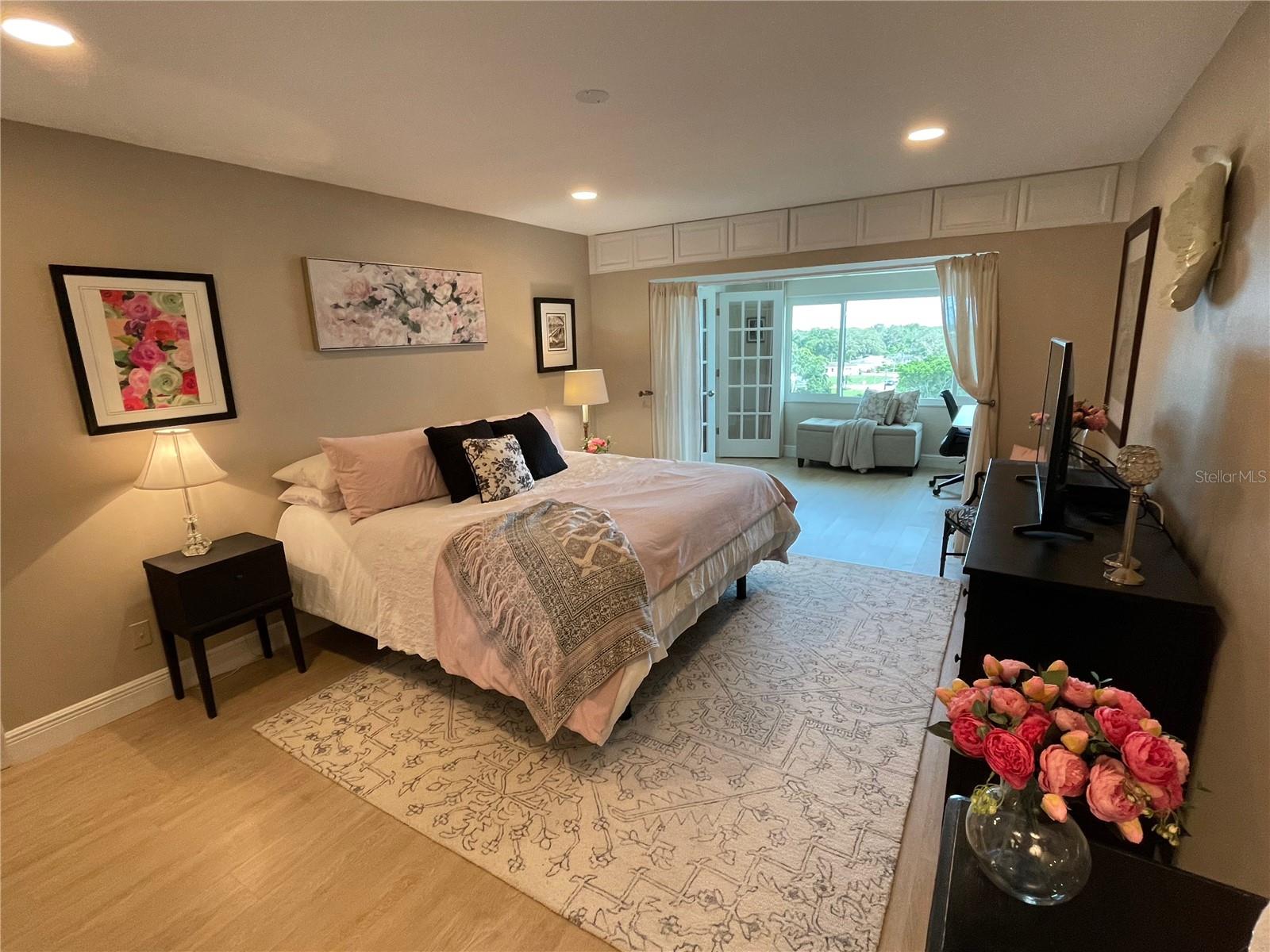 Primary Bedroom w/built-in storage cabinets above and Office Nook